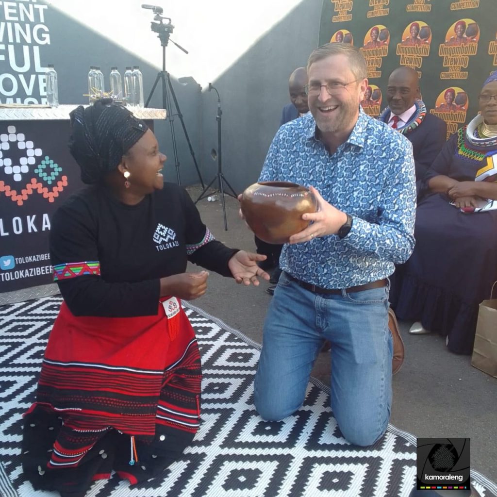 Aphiwe teaching the world how sacred our traditional beer is, at the Umqombothi brewing competition in 2023